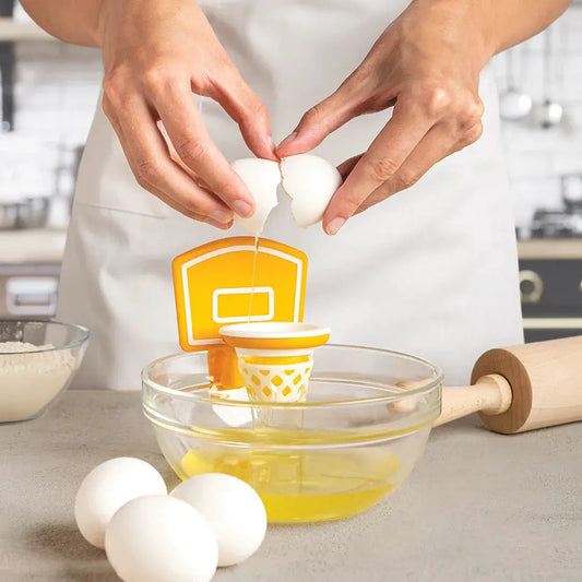 Dunk N' Egg Egg Separator by OTOTO DESIGN in orange and white over a glass bowl with eggs on Tampa Home & Garden Store