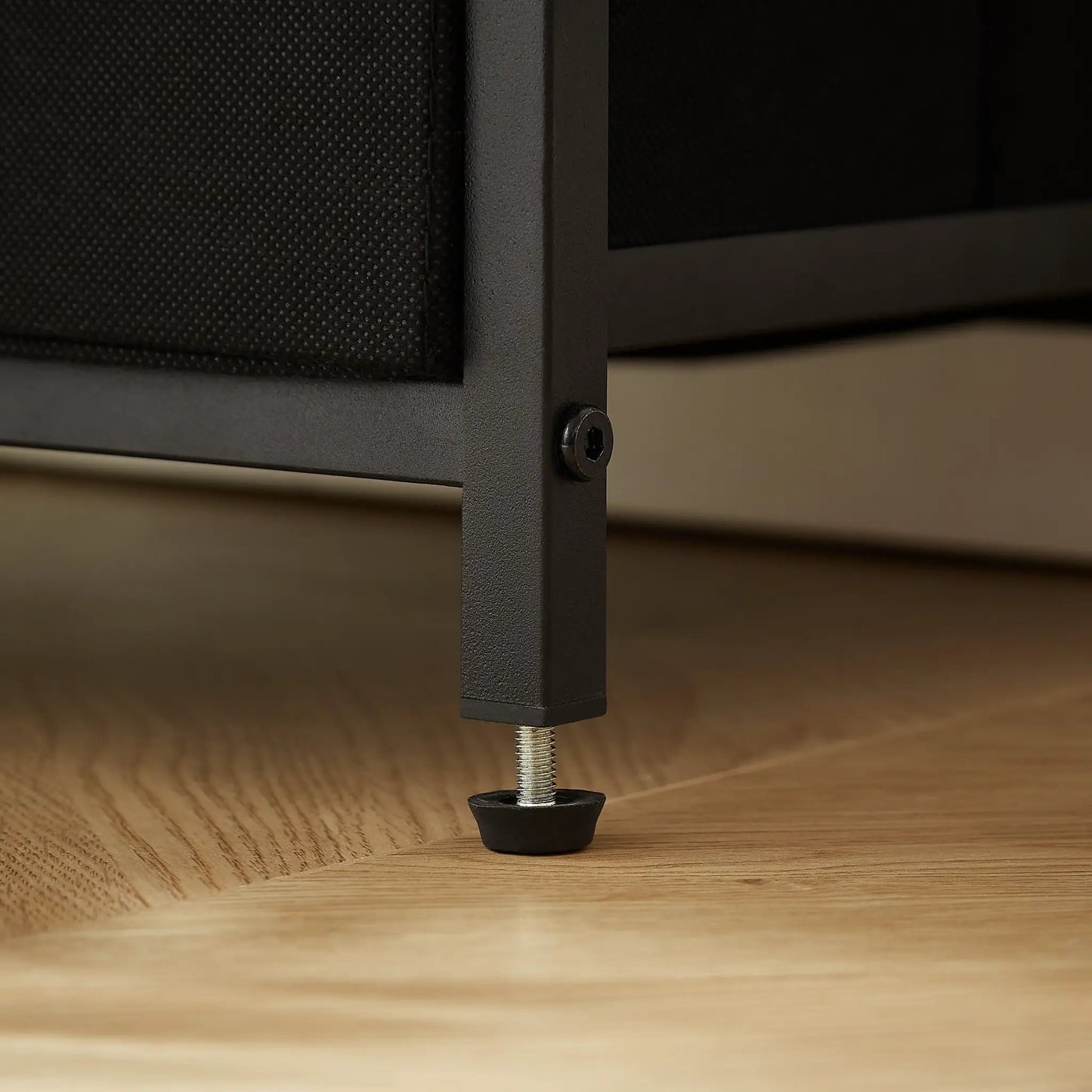 Tea table leg in matte black metal with an adjustable threaded foot on a wood floor on Tampa Home & Garden Store