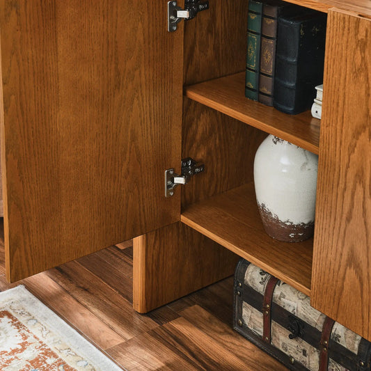 Walnut sideboard buffet cabinet with storage, open shelf showing books and a ceramic vase in warm wood interior on Tampa Home & Garden Store