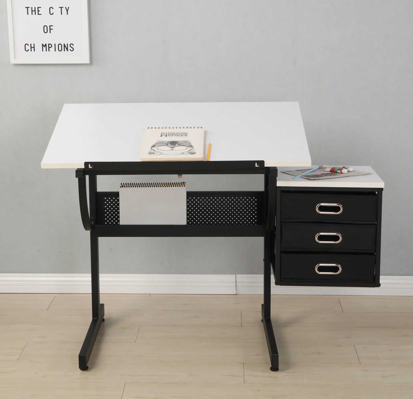 White adjustable drafting table with black metal frame and three-drawer storage on right on Tampa Home & Garden Store