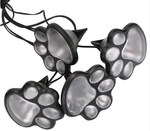 Paw-shaped outdoor solar 4 LED lights, 4-pack, black plastic with translucent paw pads on Tampa Home & Garden Store