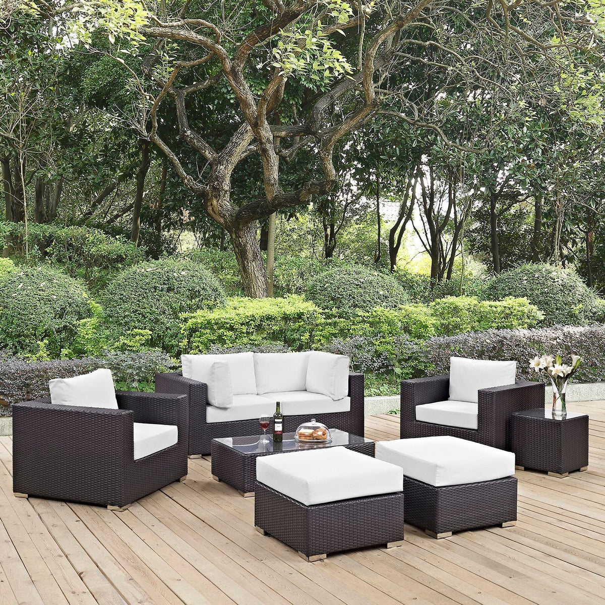 Convene 8 Piece Outdoor Patio Sectional Set with dark wicker frames and white cushions on a wooden deck on Tampa Home & Garden Store