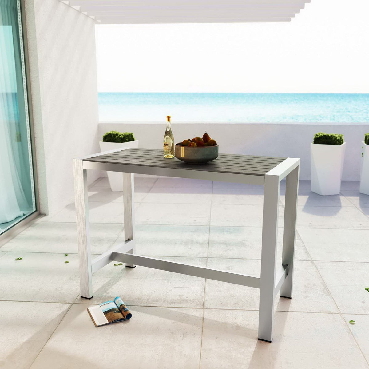 Shore Outdoor Patio Aluminum Rectangle Bar Table in silver-gray on a sunny patio with sea view on Tampa Home & Garden Store