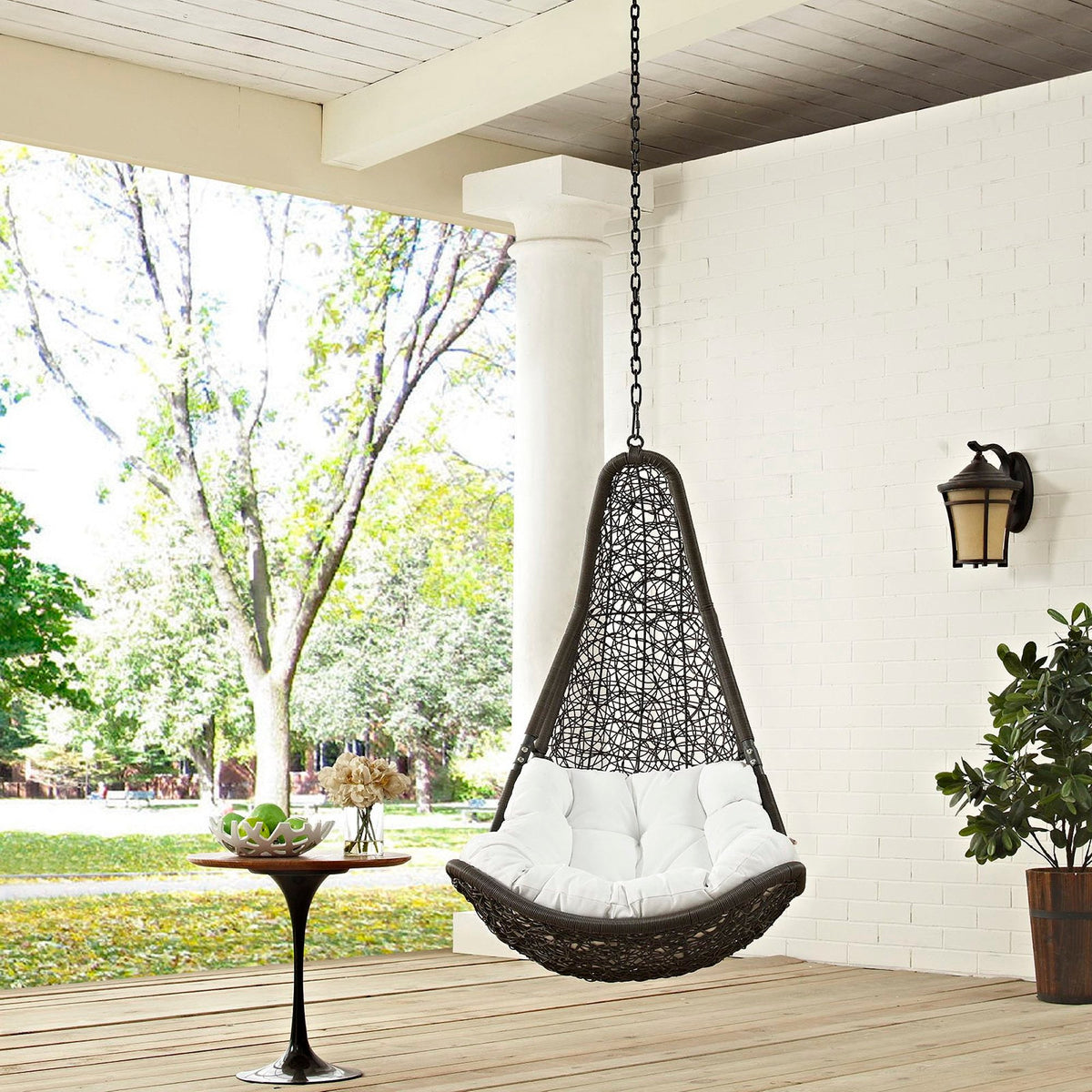 Abate outdoor patio swing chair without stand, dark wicker and white cushions on a porch on Tampa Home & Garden Store