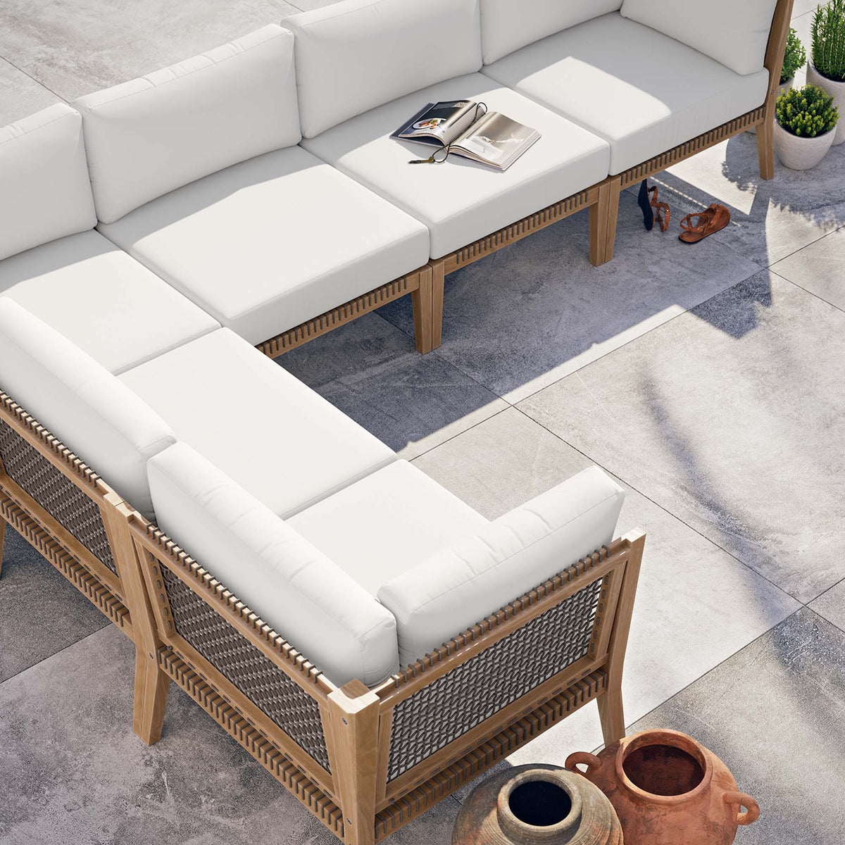 Clearwater 6pc Teak Wood Sectional Sofa with white cushions and woven sides on a patio on Tampa Home & Garden Store