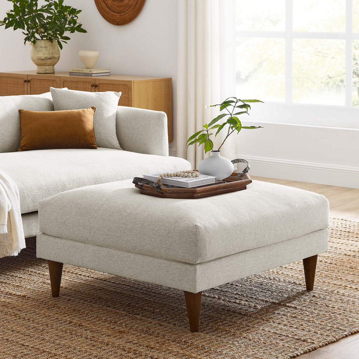 Zoya Down Filled Overstuffed Ottoman with soft gray upholstery and tapered wooden legs on Tampa Home & Garden Store