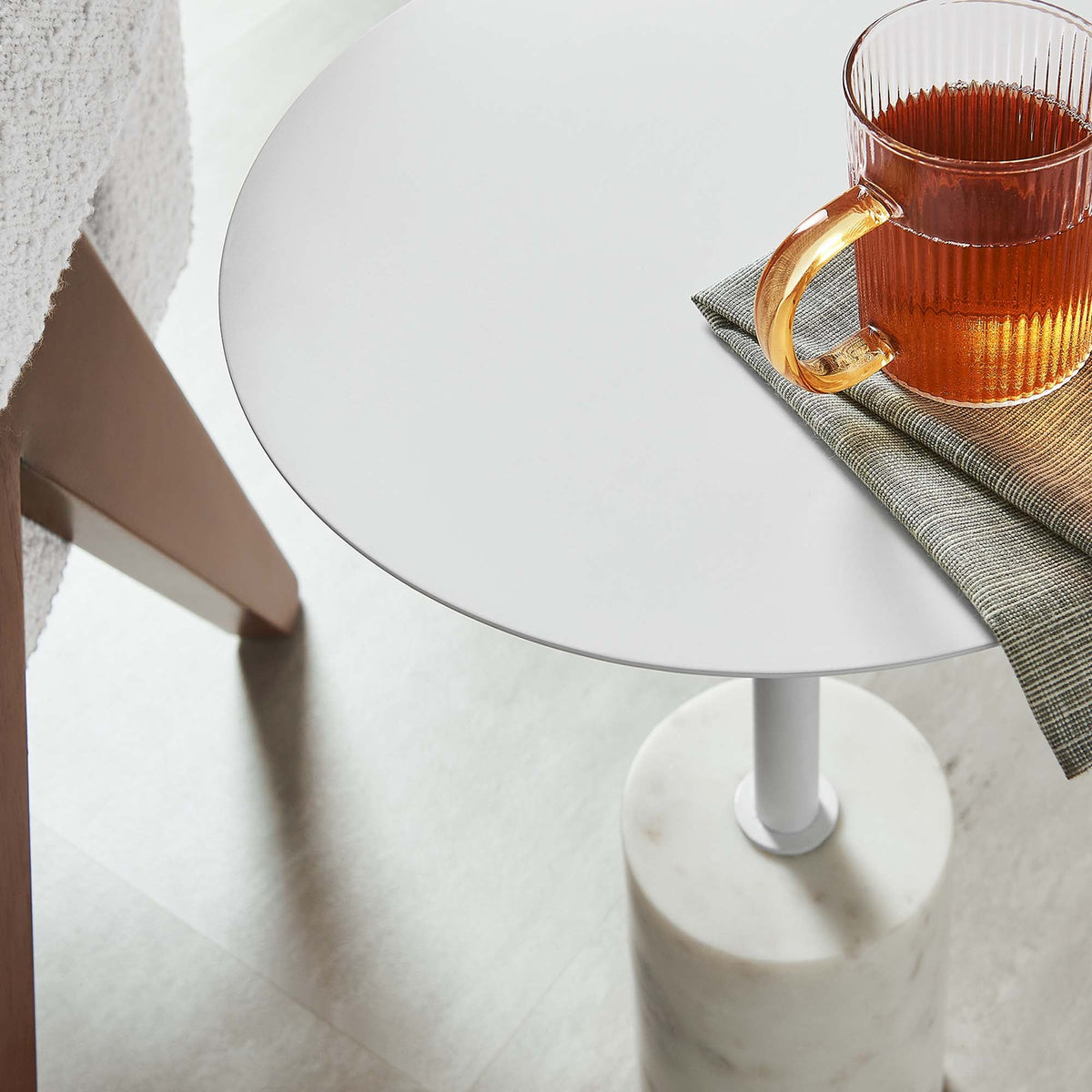 Lyric Round Side Table white round top with pedestal base on gray napkin on Tampa Home & Garden Store