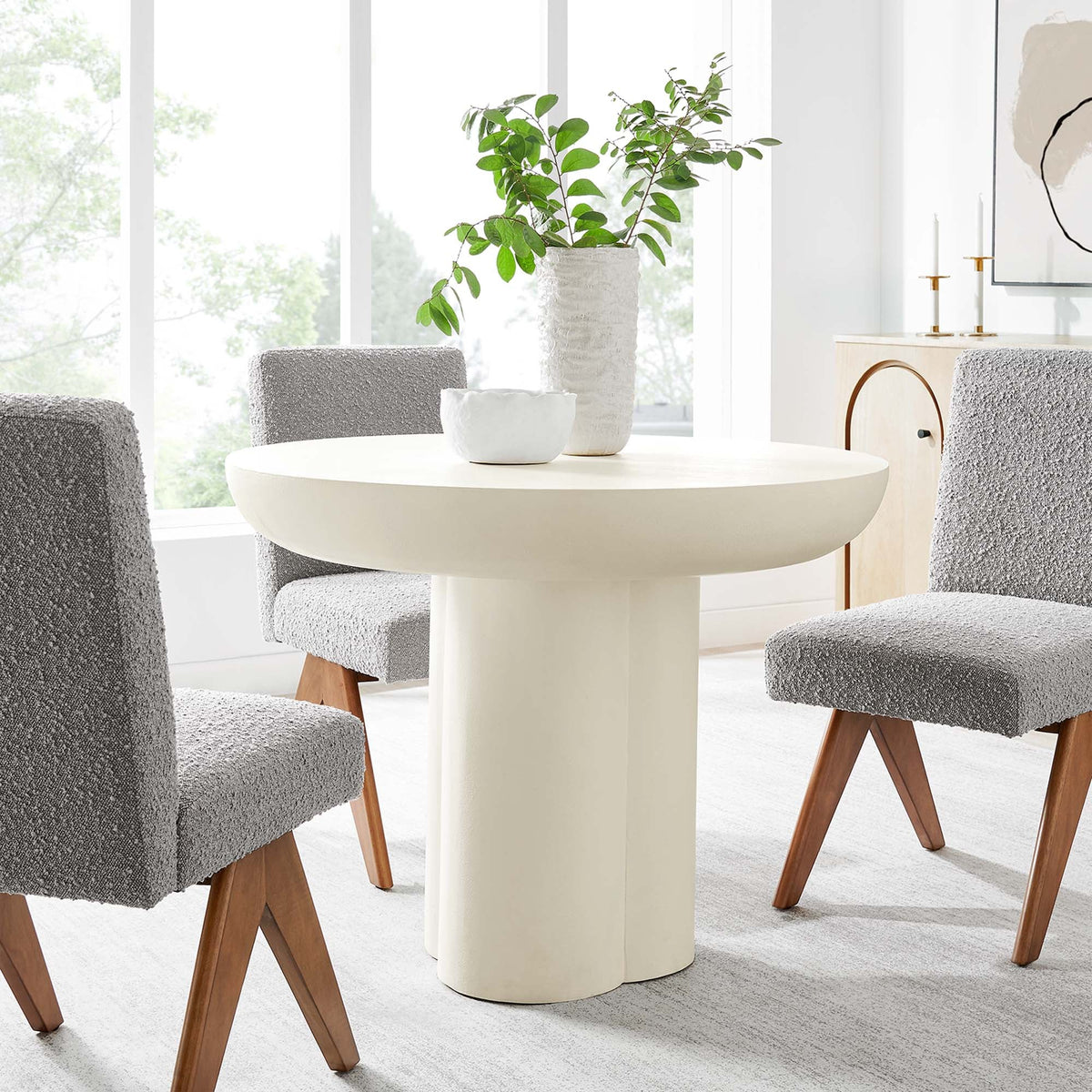 Caspian 40in round dining table with white pedestal base in a bright room with gray chairs on Tampa Home & Garden Store