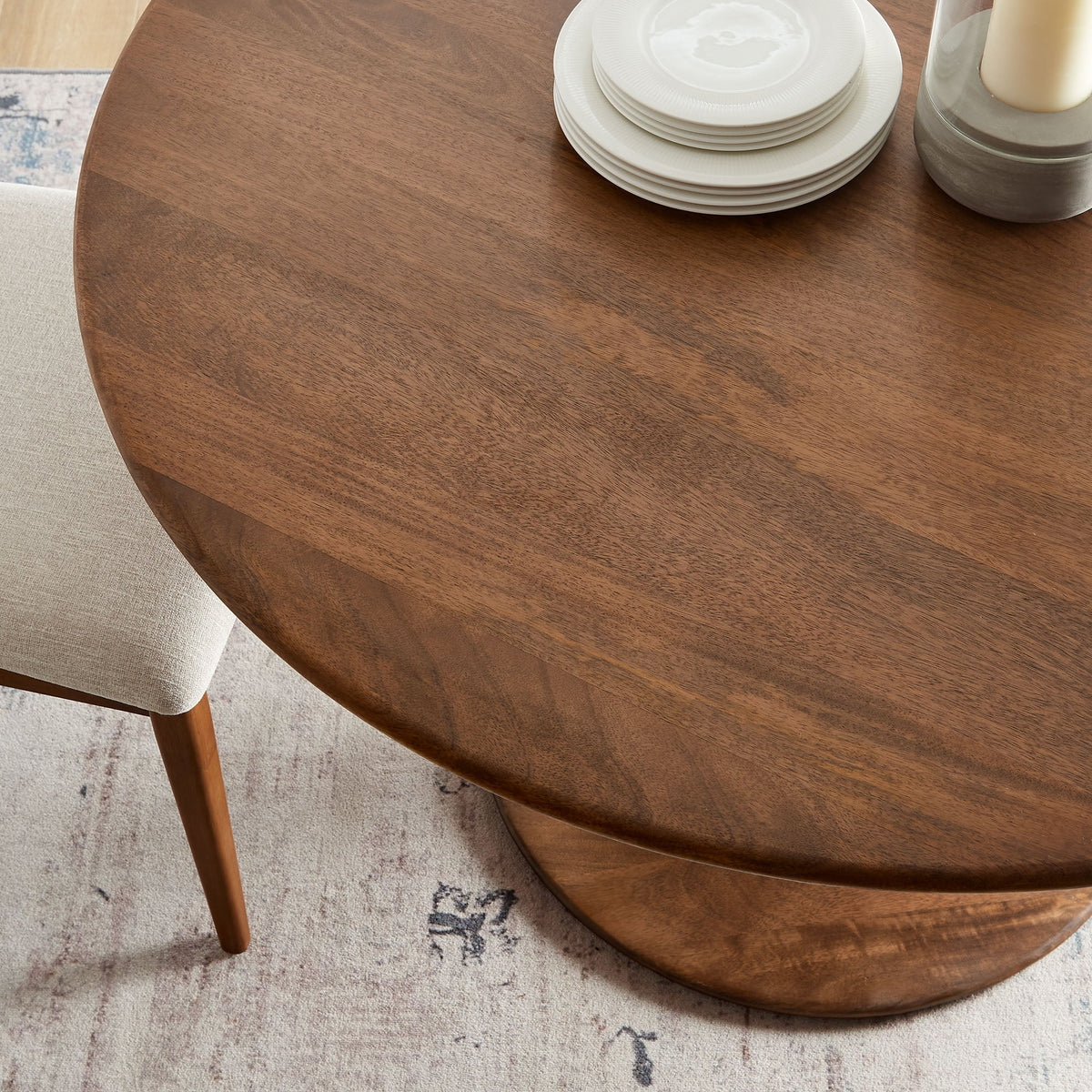 Lippa 48in round solid wood dining table with white plates and candle holder on Tampa Home & Garden Store