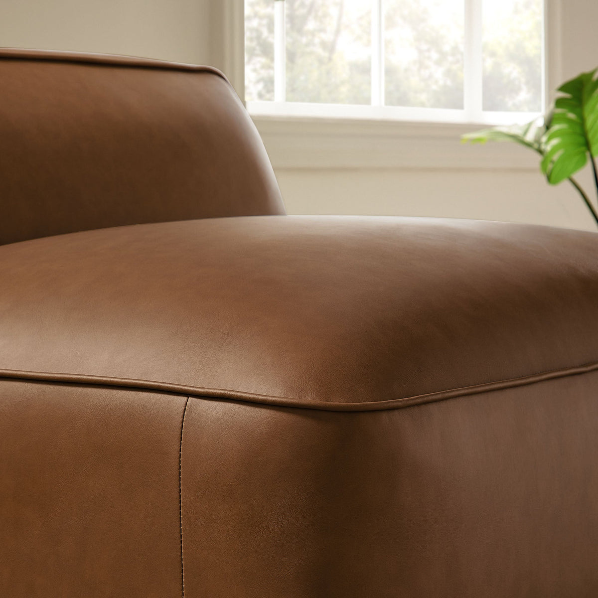 Auren vegan leather armless chair in brown with seam detail, close-up view on Tampa Home & Garden Store