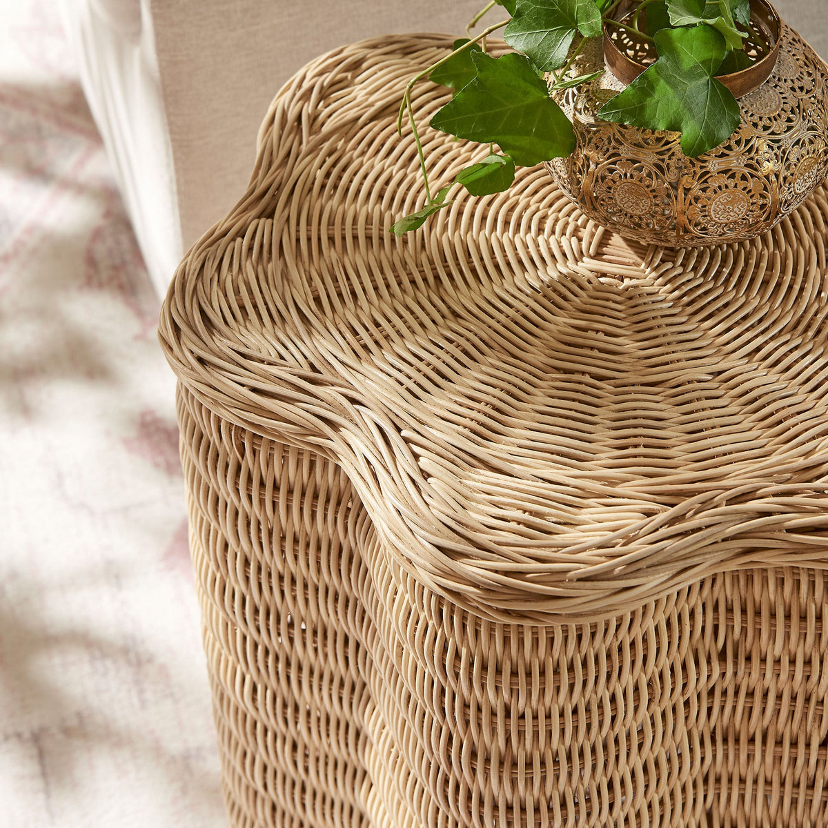 Erika scalloped natural rattan side table Modway with tan weave, metal vase with ivy on Tampa Home & Garden Store