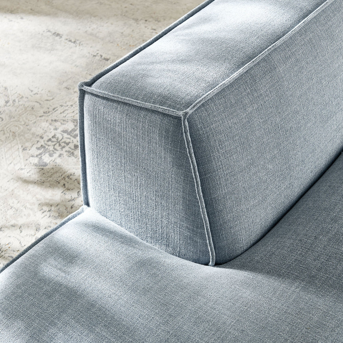 Left-facing armless modular chaise in gray Restore Performance fabric with piped seams on Tampa Home & Garden Store