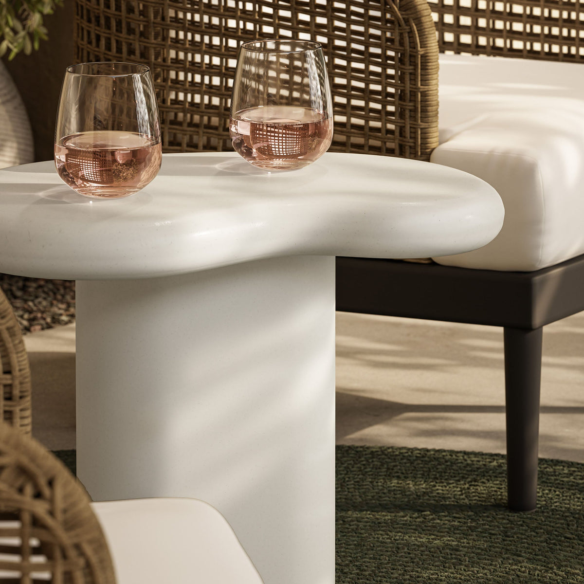 Elowen Outdoor Patio Side Table by Modway with 2 pink stemware on a white round tabletop on Tampa Home & Garden Store