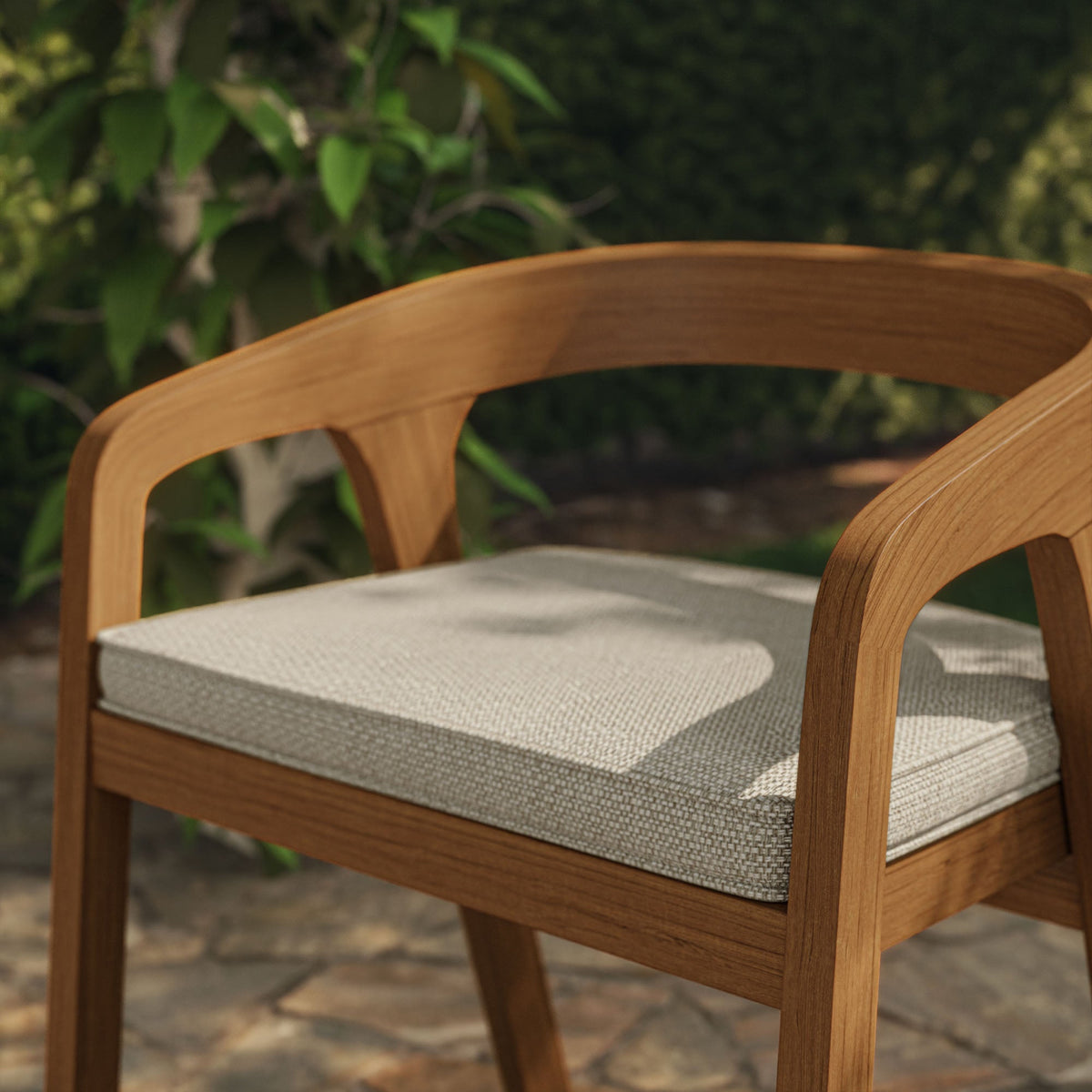 Kona outdoor teak wood barrel dining chair with light beige woven cushion in natural finish on Tampa Home & Garden Store