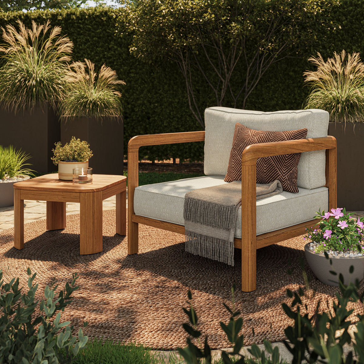 Teak Kona outdoor sofa with beige cushions beside a teak side table on a woven rug on Tampa Home & Garden Store