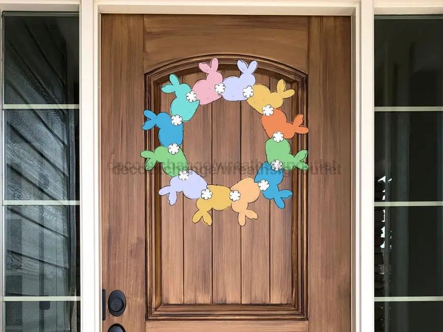 Easter Rabbit Wood Sign Door Hanger with pastel bunny shapes forming a circle on a wood door on Tampa Home & Garden Store