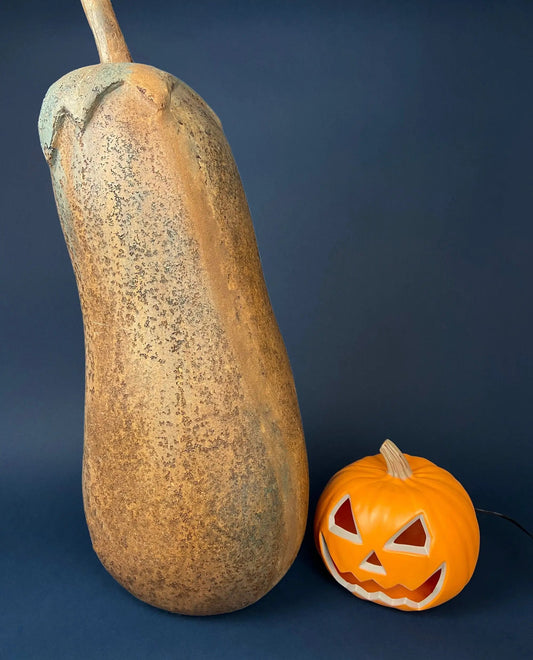 Extra Large 34-Inch Gourd Pumpkin with textured beige body beside a jack-o-lantern for fall decor on Tampa Home & Garden Store