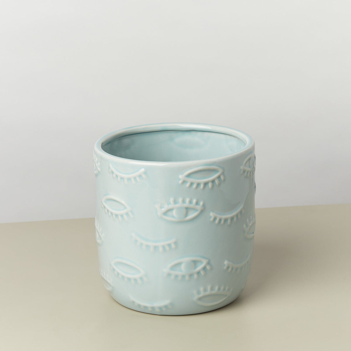 Eyes Pot 7 Inch ceramic planter in pale blue with embossed eye motifs on Tampa Home & Garden Store