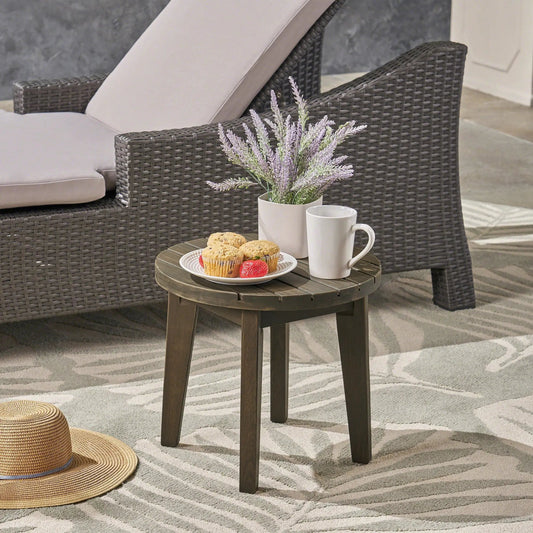 Outdoor 16 Inch Acacia Wood Side Table Gray with round, slatted top beside wicker seating on Tampa Home & Garden Store