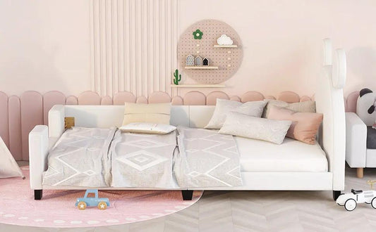 Twin Daybed with Carton Ears, white upholstered frame with soft bedding in a pink space on Tampa Home & Garden Store