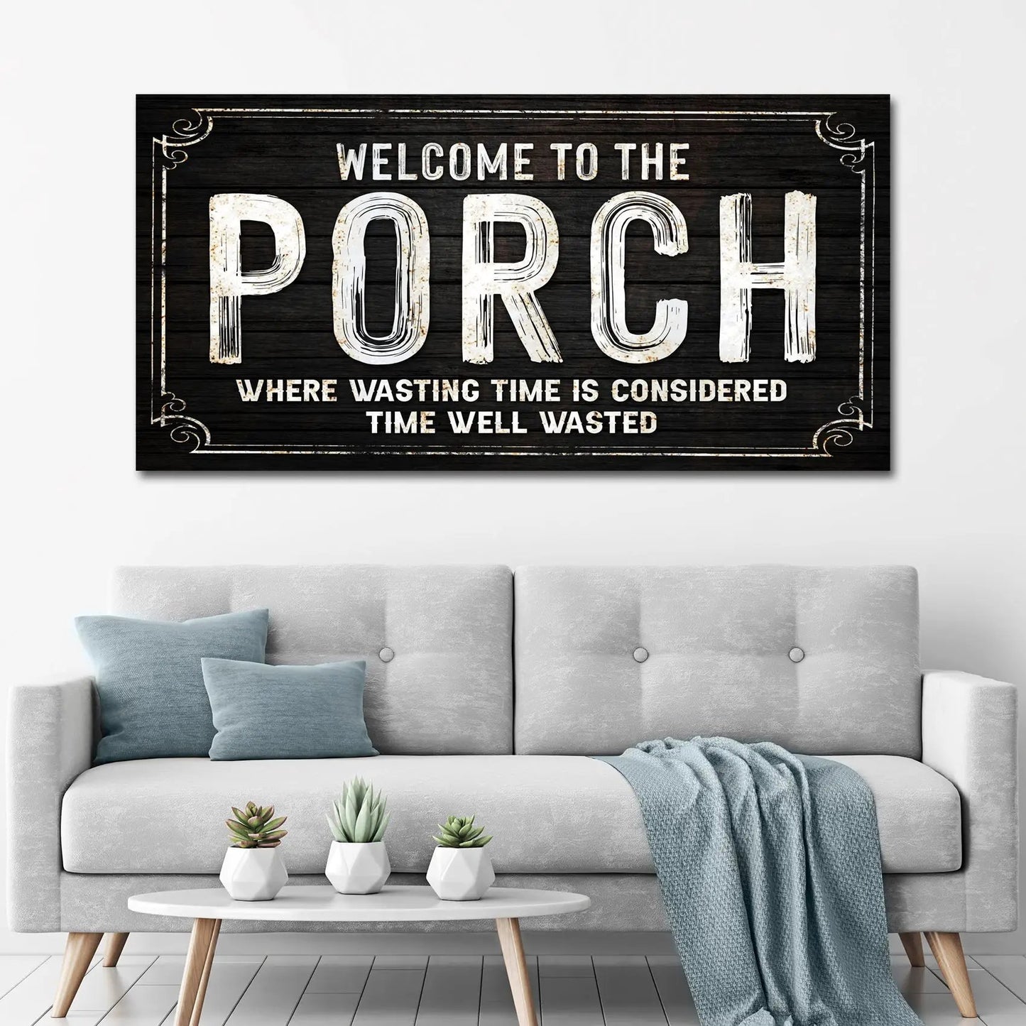 Canvas porch sign Tailored Canvases with white distressed lettering on dark wood on Tampa Home & Garden Store