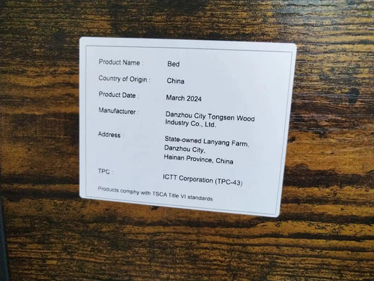 Bed Frame with Charging Station label on rustic brown wood showing origin China and Mar 2024 on Tampa Home & Garden Store