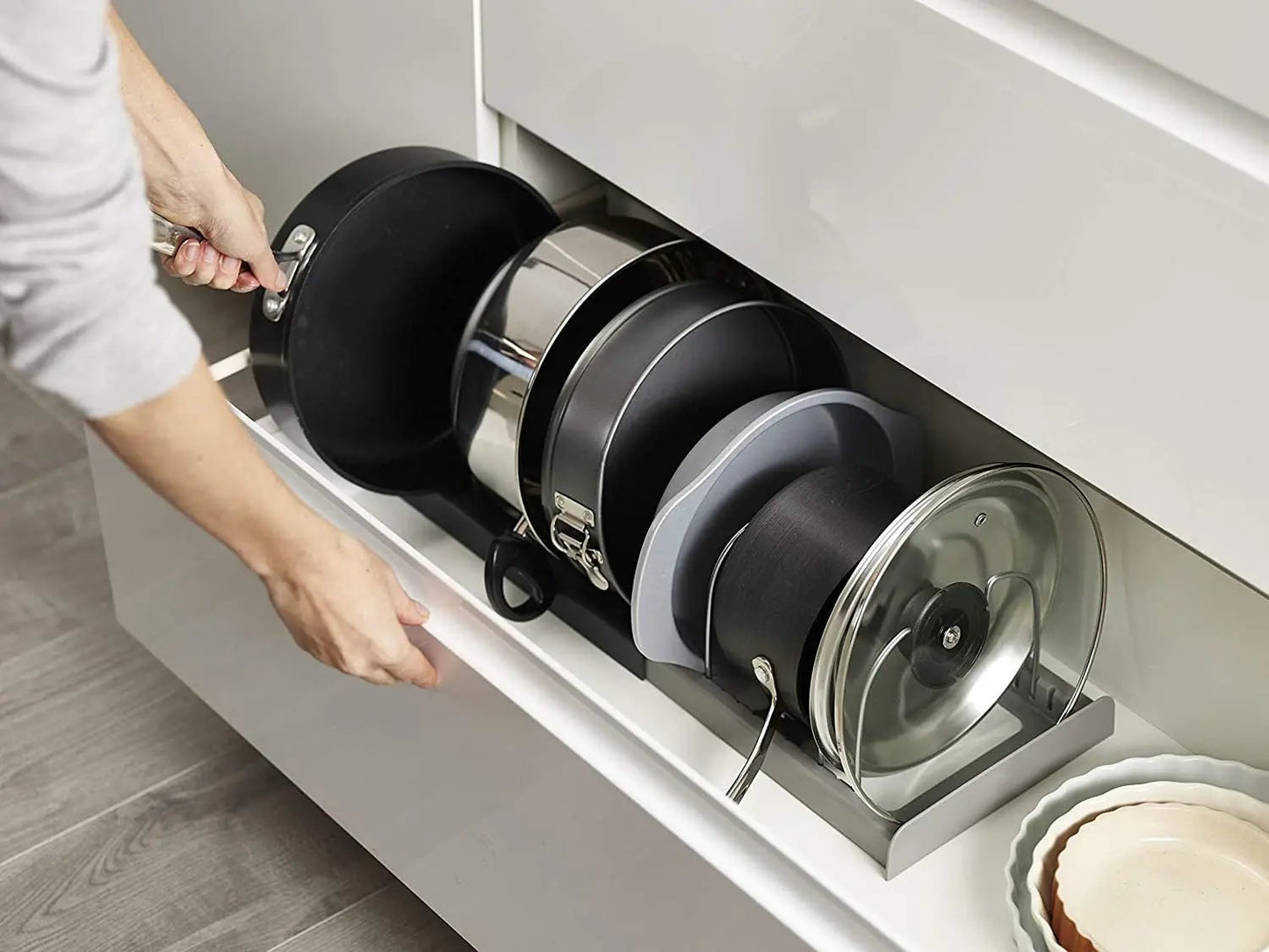 Tabletop Pot Cover Rack and Utensil Organizer with black and stainless pots in a pull-out drawer on Tampa Home & Garden Store