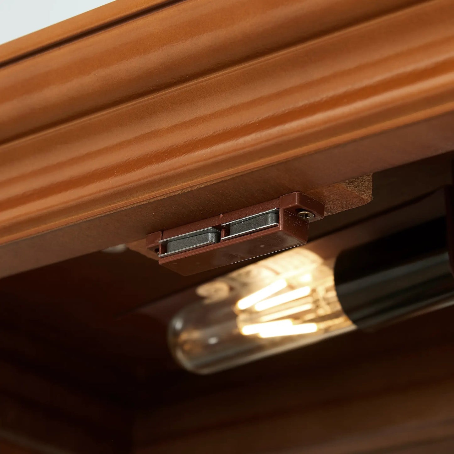 Walnut curio cabinet edge with metal hinge hardware and warm wood finish on Tampa Home & Garden Store