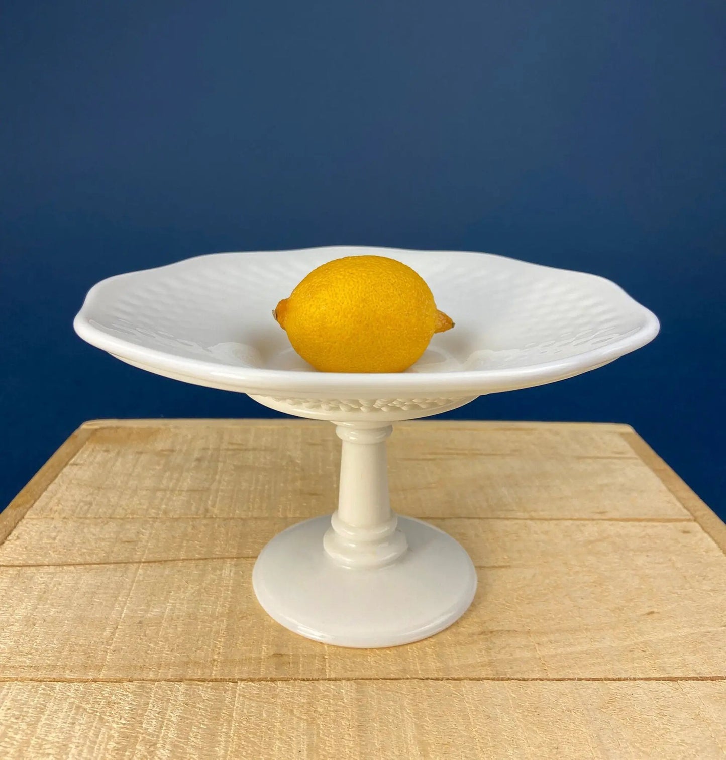 Milk glass footed compote on pedestal, white bowl with smooth rim on wooden table on Tampa Home & Garden Store