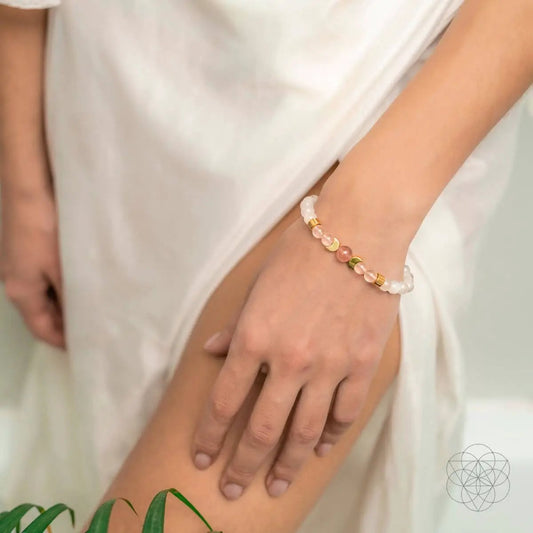 Rose Quartz Fertility Bracelet by Conscious Items with pink beads and gold spacers on wrist on Tampa Home & Garden Store