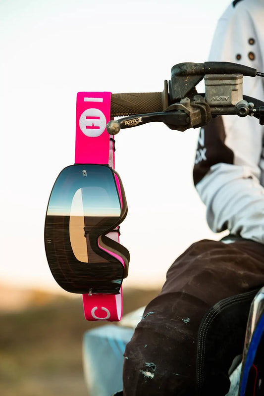 Goggles Havoc Infinity with pink strap and mirrored lenses hanging from motorcycle handlebar on Tampa Home & Garden Store