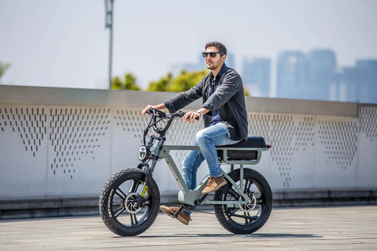 FLASH AWD 1.0 electric bicycle by EUNORAU E-BIKE US, olive frame, fat tires, rider in sunglasses on Tampa Home & Garden Store