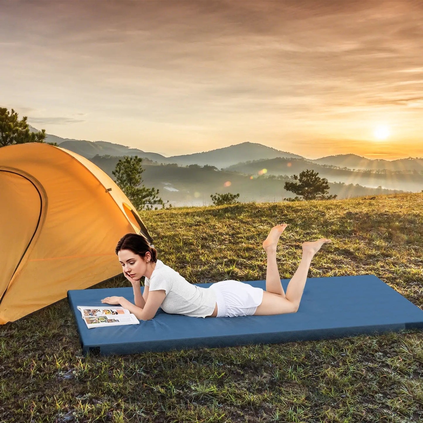 Foldable camping mattress in blue with anti-slip bottom on grassy campsite near a tent on Tampa Home & Garden Store