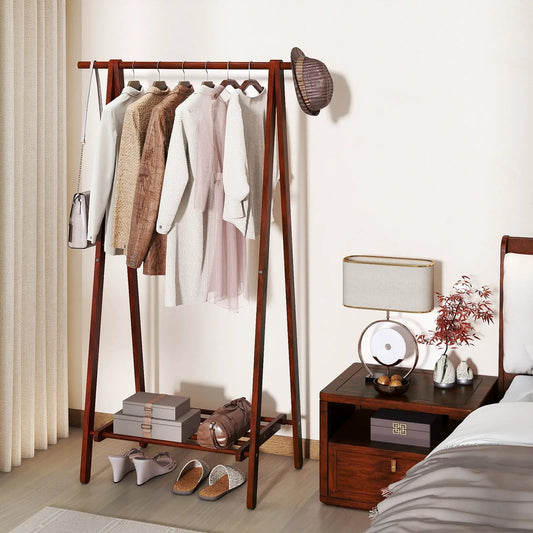 Folding rubber wood clothes rack in walnut finish with hanging clothes and bottom storage shelf on Tampa Home & Garden Store
