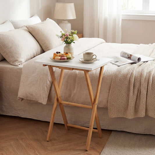 Folding TV Tray Tables set of 2 bamboo with white tops by DirectDeals on a bed on Tampa Home & Garden Store