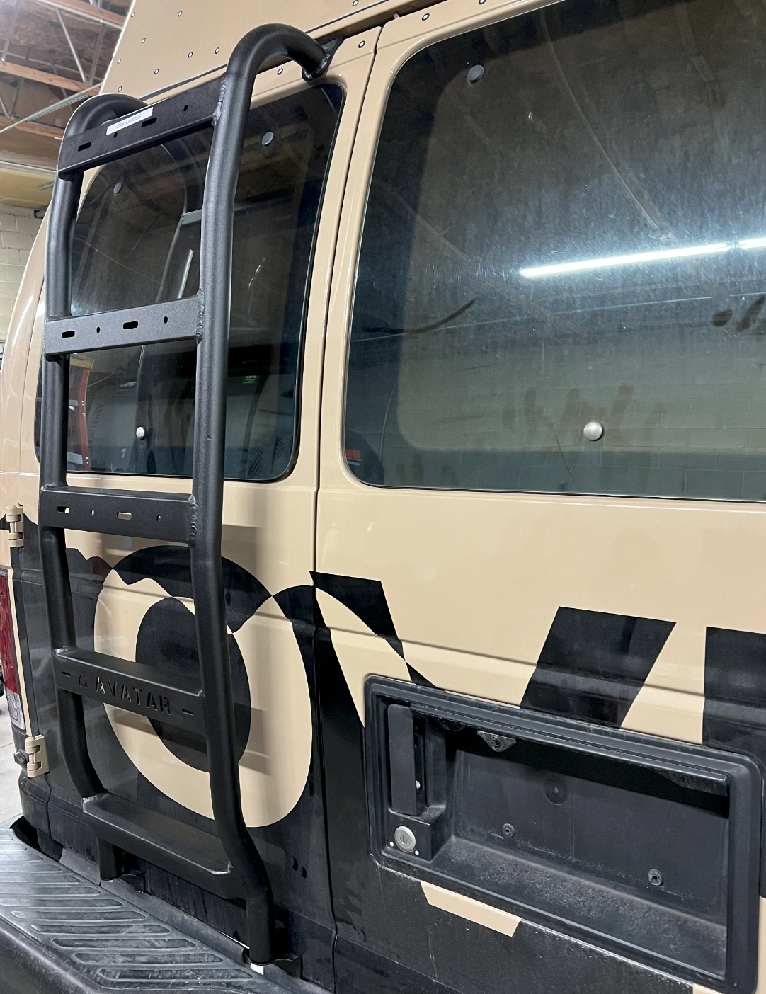Ford E-Series Rear Ladder by Avatar Offroad, black steel ladder with curved rails on tan van on Tampa Home & Garden Store