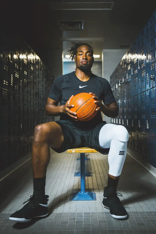 Full-Length Padded Knee Sleeve White by Cumulus Sport on right knee in locker room on Tampa Home & Garden Store