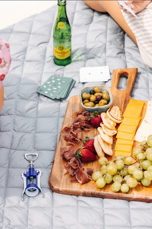 Waterproof puffer blanket with pockets in light gray, Pretty Rugged blanket on picnic board on Tampa Home & Garden Store