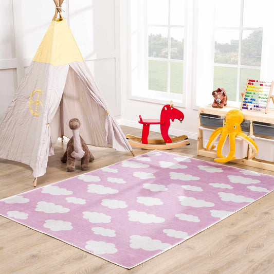 Nizar Pink Cloud washable kids rug with white cloud pattern in pink placed in a kid's playroom on Tampa Home & Garden Store