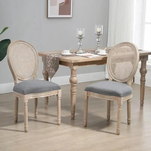 Set of 2 upholstered armless rattan dining chairs with grey cushions and caned backs on Tampa Home & Garden Store