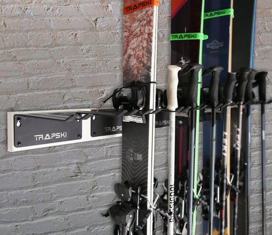Garage ski rack wall mount by TRAPSKI holds several skis with neon green straps on Tampa Home & Garden Store