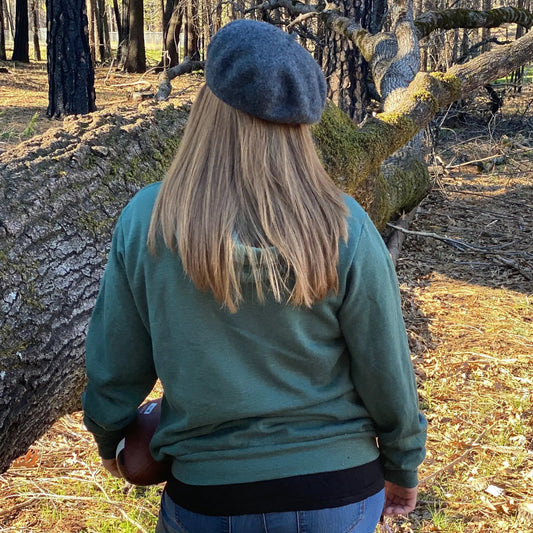 Go Tell the Bees I Am Gone Embroidered Sweatshirt green crewneck worn by person in woods on Tampa Home & Garden Store