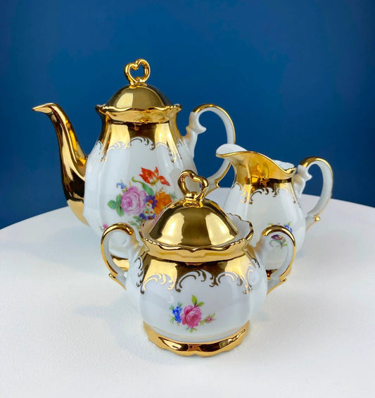 Gold demitasse tea set for two with hand-painted floral motifs and gilded trim on Tampa Home & Garden Store