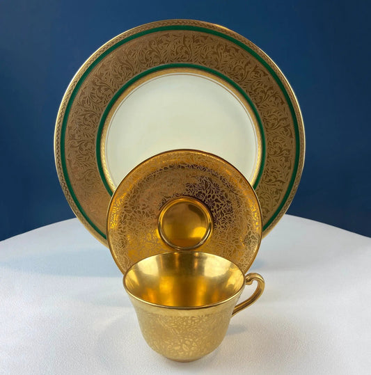 Gold on Gold teacups and saucers set with gilded Hutschenreuther pattern and green rims on display on Tampa Home & Garden Store