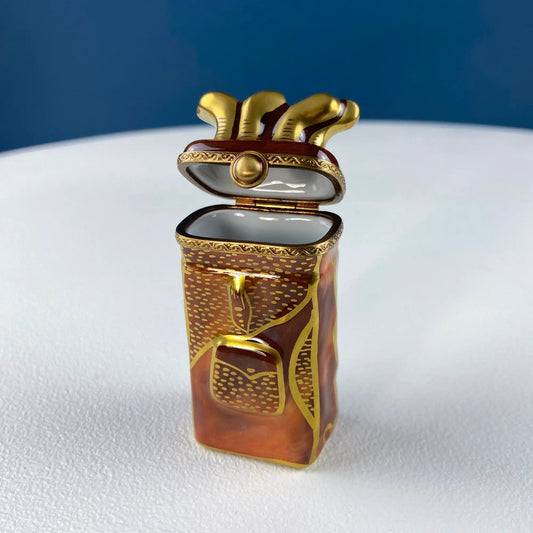 Miniature golf club bag porcelain Limoges box with gold-tone clubs and ornate trim on Tampa Home & Garden Store