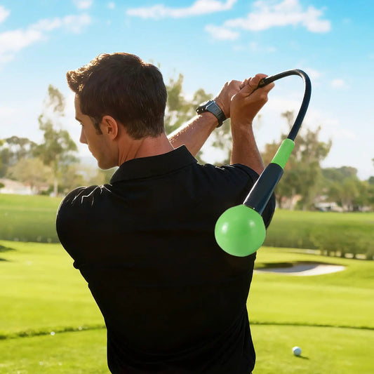 Golf swing trainer with weighted head and curved handle; outdoors practice with green ball on Tampa Home & Garden Store