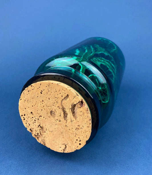Green glass storage jar with cork lid, marbled emerald design, stacked on blue background on Tampa Home & Garden Store