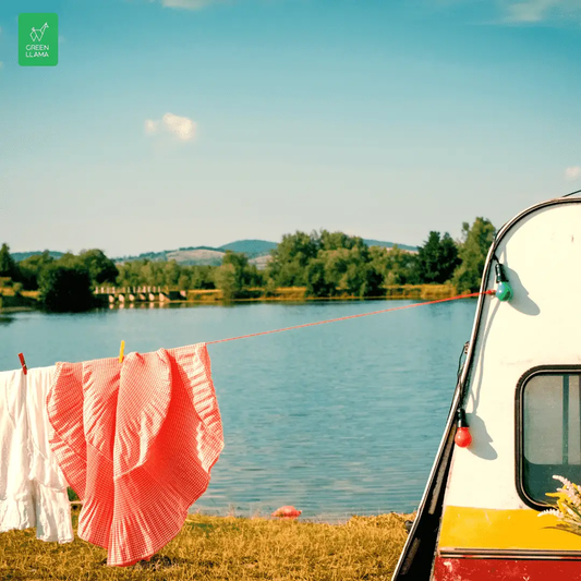 Green Llama travel laundry soap bundle on a lakeside line with white laundry beside a camper on Tampa Home & Garden Store