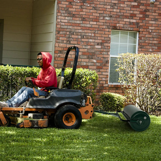 Metal lawn roller with detachable gripping handle, steel roller beside riding lawn mower on Tampa Home & Garden Store