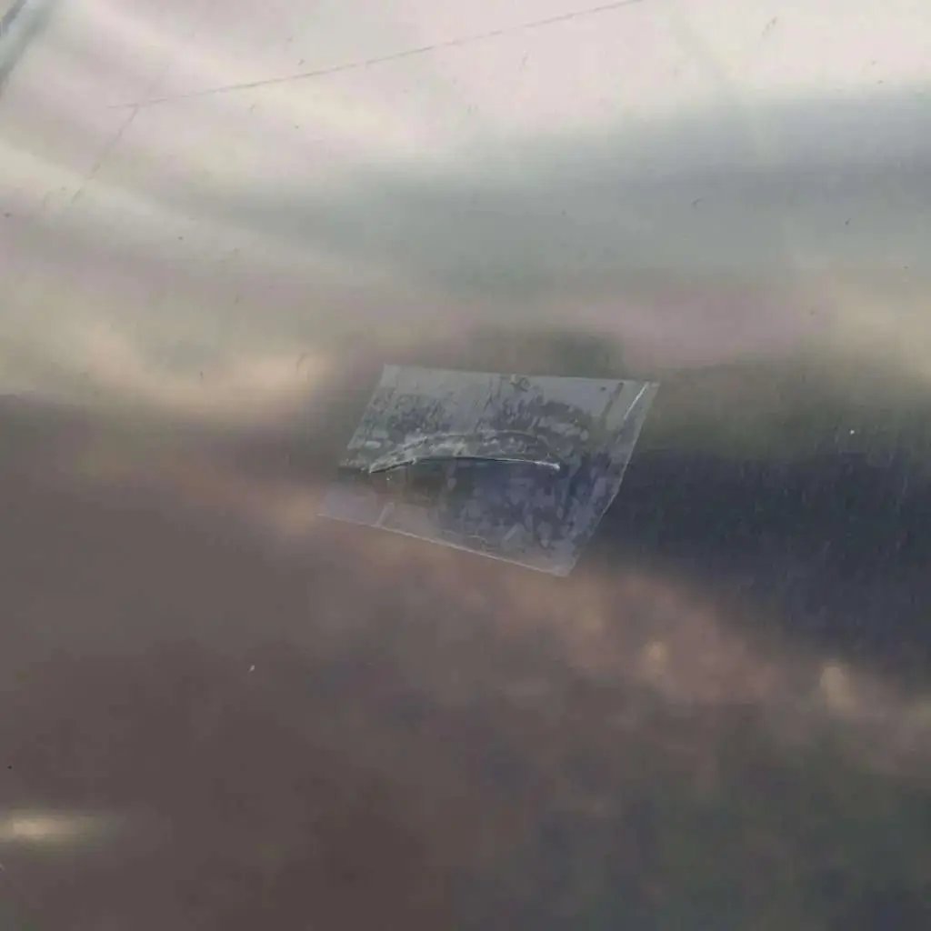 Greenhouse plastic repair tape patch on clear film showing tear repair on Tampa Home & Garden Store